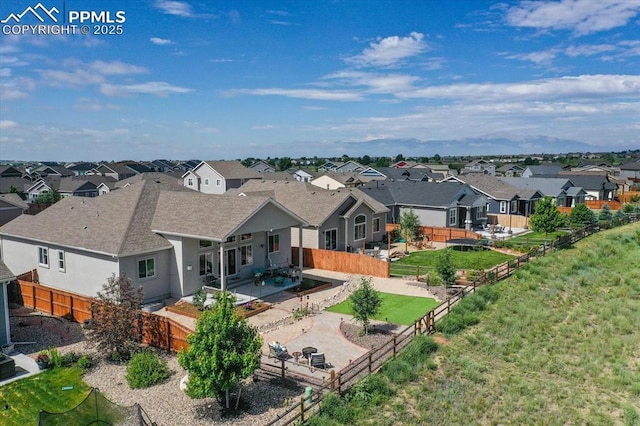 12646 Windingwalk Dr, Peyton, CO 80831 - back of property with a residential view, a fenced backyard, stucco siding, roof with shingles, and a patio