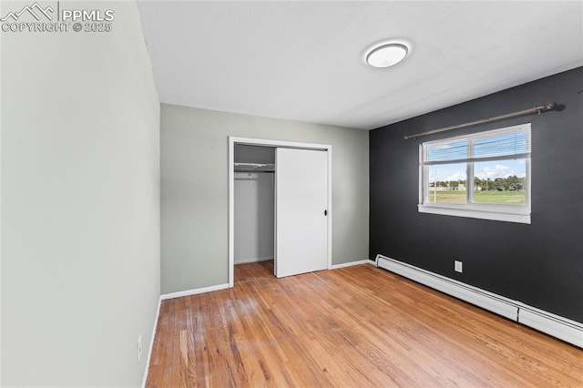 232 S Hancock Ave, Colorado Springs, CO 80903 - unfurnished bedroom featuring a baseboard radiator, a closet, and light wood-style flooring