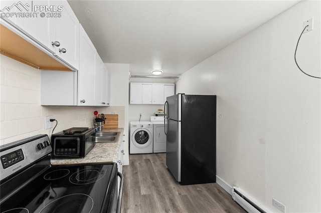 232 S Hancock Ave, Colorado Springs, CO 80903 - kitchen featuring appliances with stainless steel finishes, washing machine and clothes dryer, white cabinetry, light wood-style floors, and light countertops