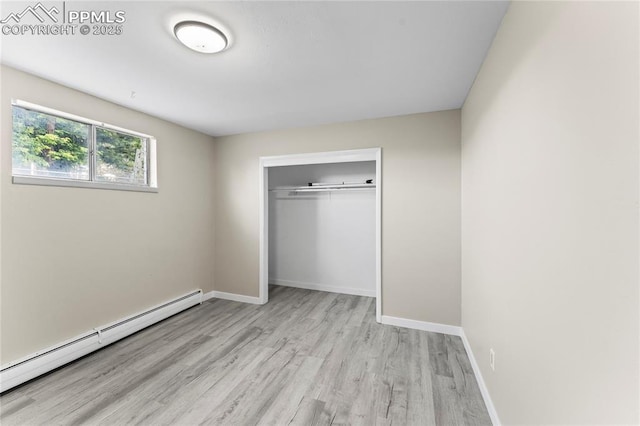 232 S Hancock Ave, Colorado Springs, CO 80903 - unfurnished bedroom featuring a baseboard heating unit, wood finished floors, and a closet