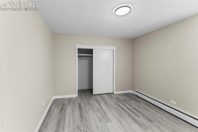 232 S Hancock Ave, Colorado Springs, CO 80903 - unfurnished bedroom featuring baseboard heating, wood finished floors, and a closet