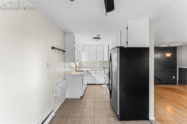 232 S Hancock Ave, Colorado Springs, CO 80903 - kitchen with freestanding refrigerator, white cabinets, light countertops, light tile patterned flooring, and a ceiling fan
