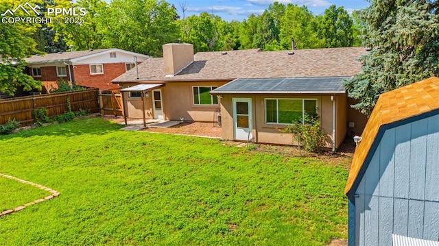 1105 Parkview Blvd, Colorado Springs, CO 80905 - rear view of house with a fenced backyard, a chimney, and a storage shed