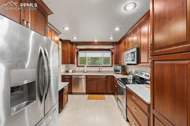 1105 Parkview Blvd, Colorado Springs, CO 80905 - kitchen with stainless steel appliances, light tile patterned floors, recessed lighting, and light stone counters
