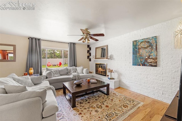 1105 Parkview Blvd, Colorado Springs, CO 80905 - living room featuring a ceiling fan, wood finished floors, and a brick fireplace