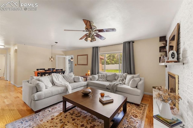 1105 Parkview Blvd, Colorado Springs, CO 80905 - living room featuring light wood-style flooring, ceiling fan, and a fireplace