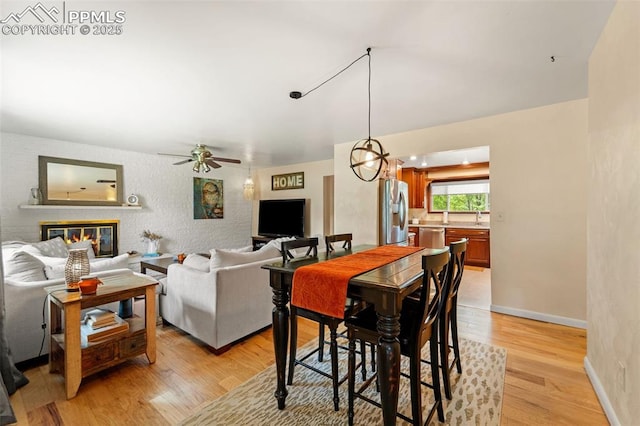 1105 Parkview Blvd, Colorado Springs, CO 80905 - dining room featuring light wood-style flooring, ceiling fan, and a glass covered fireplace