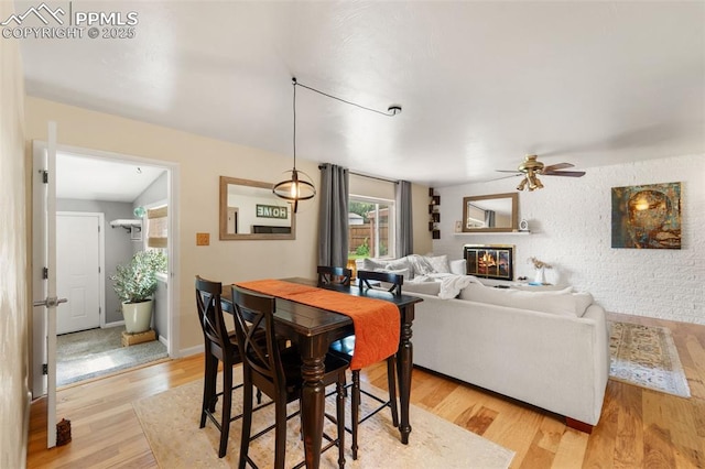 1105 Parkview Blvd, Colorado Springs, CO 80905 - dining room with ceiling fan, light wood-style floors, and a glass covered fireplace