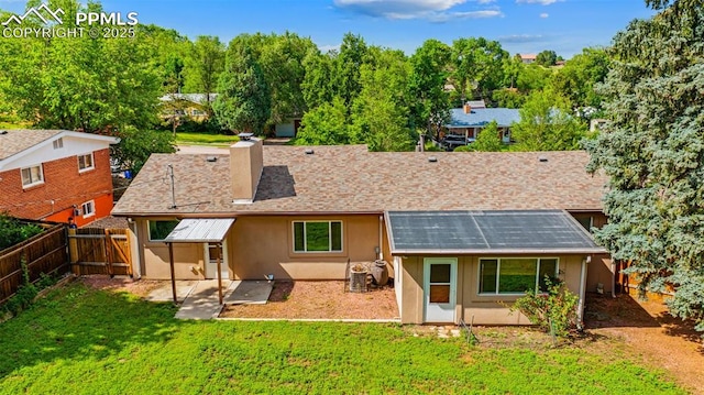 1105 Parkview Blvd, Colorado Springs, CO 80905 - rear view of house featuring a fenced backyard, stucco siding, a patio area, a chimney, and solar panels
