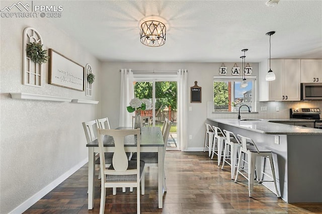 4914 Hawk Meadow Dr, Colorado Springs, CO 80916 - dining space with dark wood-style flooring and a textured ceiling