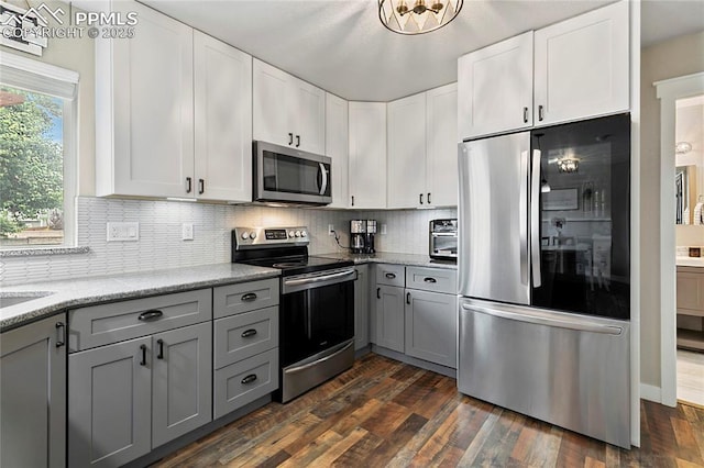 4914 Hawk Meadow Dr, Colorado Springs, CO 80916 - kitchen featuring stainless steel appliances, gray cabinets, decorative backsplash, and white cabinetry