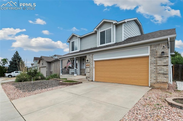 4914 Hawk Meadow Dr, Colorado Springs, CO 80916 - view of front facade featuring a porch, driveway, and stone siding