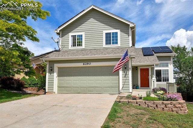 6290 Cording Ct, Colorado Springs, CO 80922 - traditional-style home with a garage, roof mounted solar panels, driveway, and a shingled roof