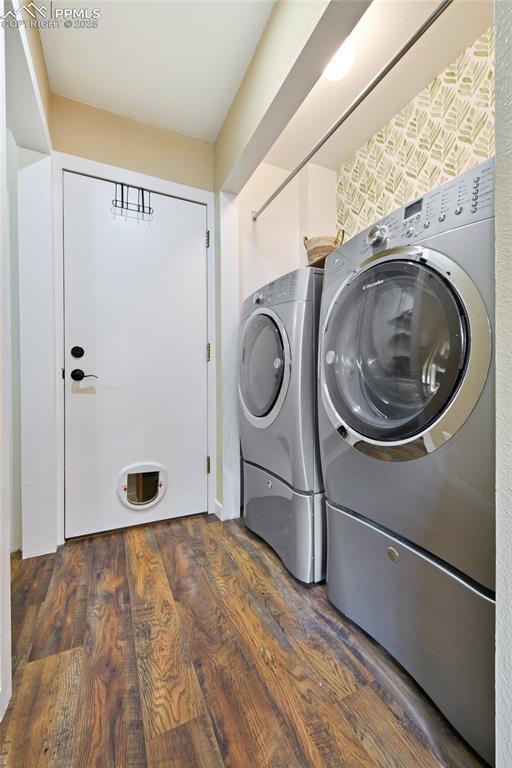 6290 Cording Ct, Colorado Springs, CO 80922 - washroom featuring washing machine and clothes dryer and wood finished floors