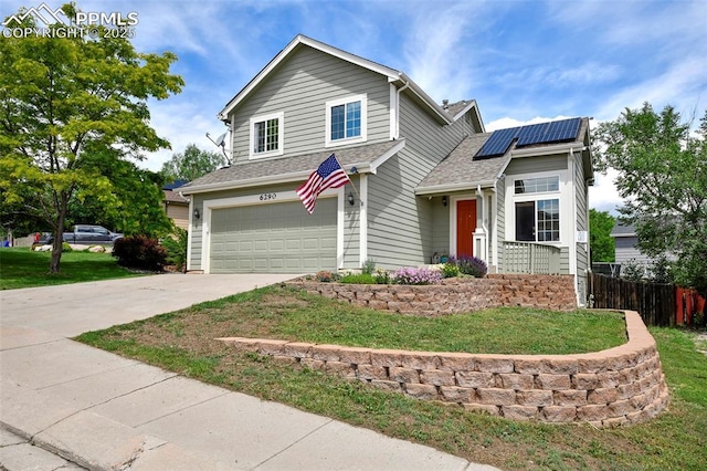 6290 Cording Ct, Colorado Springs, CO 80922 - traditional-style home with a garage, roof mounted solar panels, driveway, and roof with shingles