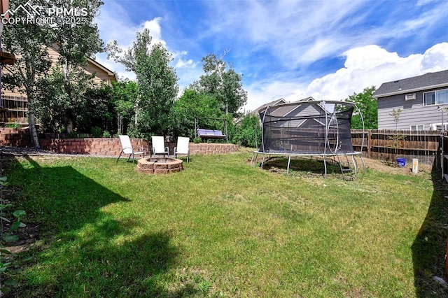 6290 Cording Ct, Colorado Springs, CO 80922 - view of yard with a trampoline and an outdoor fire pit