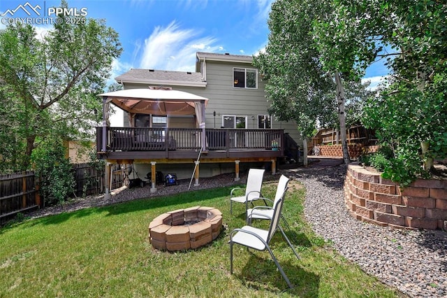 6290 Cording Ct, Colorado Springs, CO 80922 - back of house with an outdoor fire pit, a gazebo, a fenced backyard, and a deck