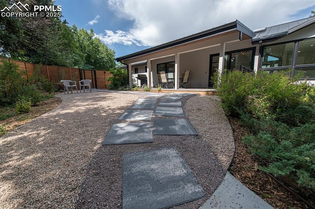 2510 Old Broadmoor Rd, Colorado Springs, CO 80906 - rear view of property featuring a patio, stucco siding, outdoor dining space, and a standing seam roof