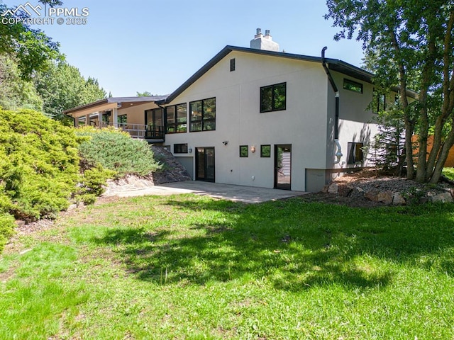 2510 Old Broadmoor Rd, Colorado Springs, CO 80906 - rear view of property featuring a patio, a chimney, a lawn, and stucco siding
