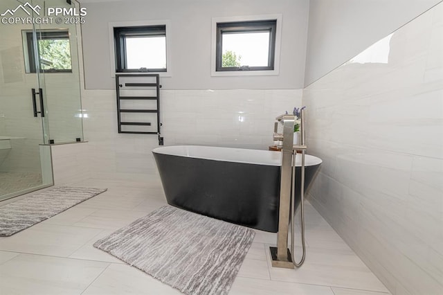 2510 Old Broadmoor Rd, Colorado Springs, CO 80906 - full bathroom featuring tile walls, a stall shower, a soaking tub, and a wainscoted wall