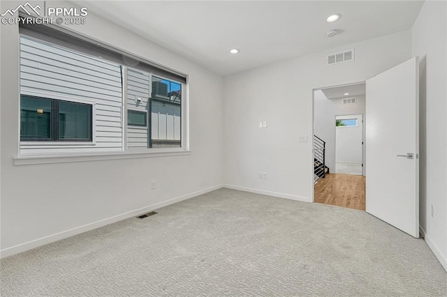 1231 Newton St, Denver, CO 80204 - carpeted empty room with recessed lighting, stairs, and a smoke detector