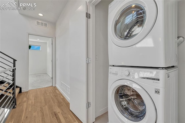 1231 Newton St, Denver, CO 80204 - laundry area featuring stacked washer / drying machine, light wood finished floors, and recessed lighting