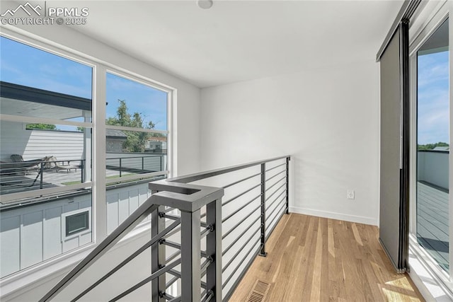 1231 Newton St, Denver, CO 80204 - hall featuring light wood finished floors and an upstairs landing