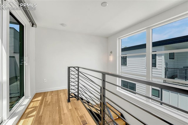 1231 Newton St, Denver, CO 80204 - hall featuring light wood finished floors and an upstairs landing