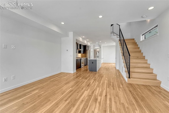 1231 Newton St, Denver, CO 80204 - unfurnished living room featuring stairway, light wood-type flooring, and recessed lighting