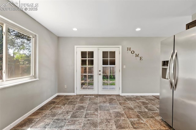 1443 Luna Dr, Fountain, CO 80817 - doorway with french doors, stone finish floors, and recessed lighting