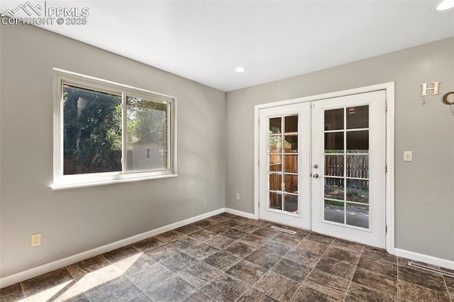 1443 Luna Dr, Fountain, CO 80817 - empty room with french doors, stone finish floors, and recessed lighting