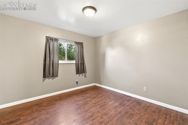 1443 Luna Dr, Fountain, CO 80817 - spare room featuring baseboards and dark wood-style floors
