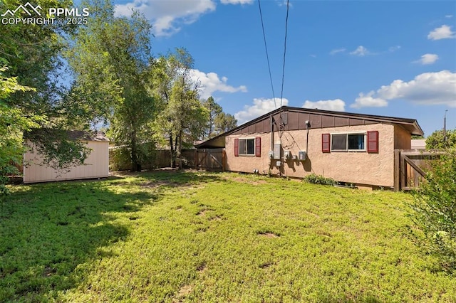 1443 Luna Dr, Fountain, CO 80817 - rear view of property with a storage shed and a fenced backyard