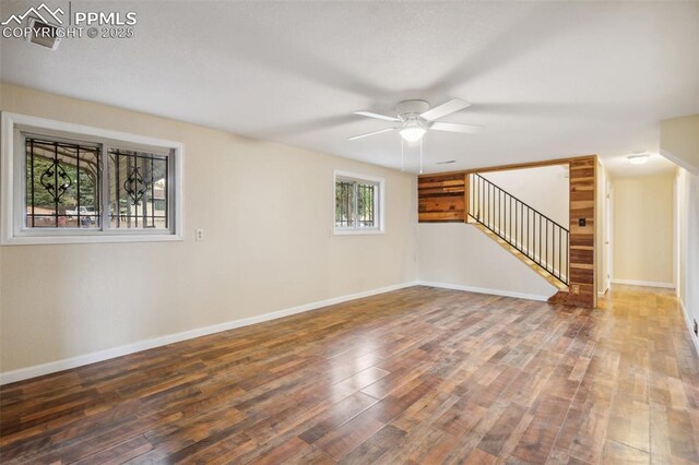 7030 Metropolitan St, Colorado Springs, CO 80911 - unfurnished living room featuring stairs, wood finished floors, and a ceiling fan