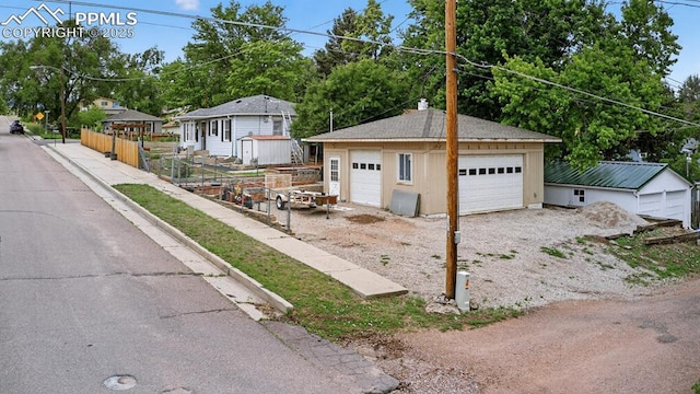 822 W Monroe St, Colorado Springs, CO 80907 - view of front facade featuring an outbuilding, a garage, and a chimney