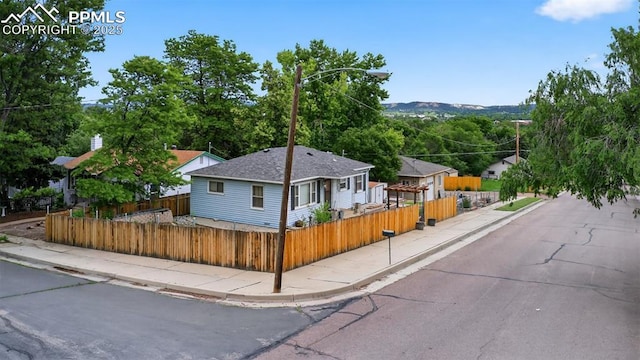 822 W Monroe St, Colorado Springs, CO 80907 - view of front of house featuring a fenced front yard and a shingled roof