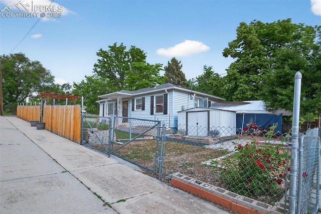 822 W Monroe St, Colorado Springs, CO 80907 - view of front of house with a gate and a storage unit