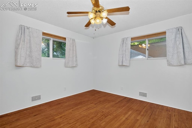 822 W Monroe St, Colorado Springs, CO 80907 - spare room featuring wood finished floors, plenty of natural light, and ceiling fan