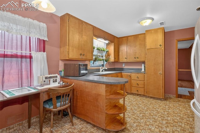 822 W Monroe St, Colorado Springs, CO 80907 - kitchen featuring black microwave, a peninsula, dark countertops, open shelves, and brown cabinetry