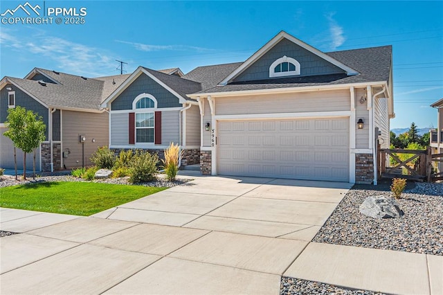 5960 Bennach Grv, Colorado Springs, CO 80927 - view of front of home featuring stone siding, a garage, concrete driveway, and a shingled roof