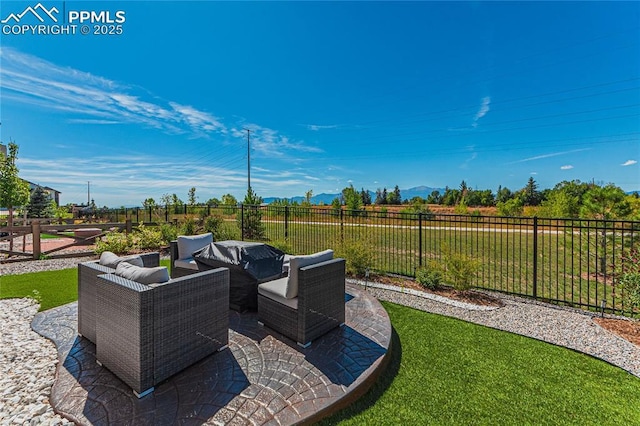 5960 Bennach Grv, Colorado Springs, CO 80927 - fenced backyard with an outdoor living space, a patio, and a mountain view