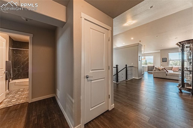 5960 Bennach Grv, Colorado Springs, CO 80927 - corridor with dark wood-type flooring and an upstairs landing