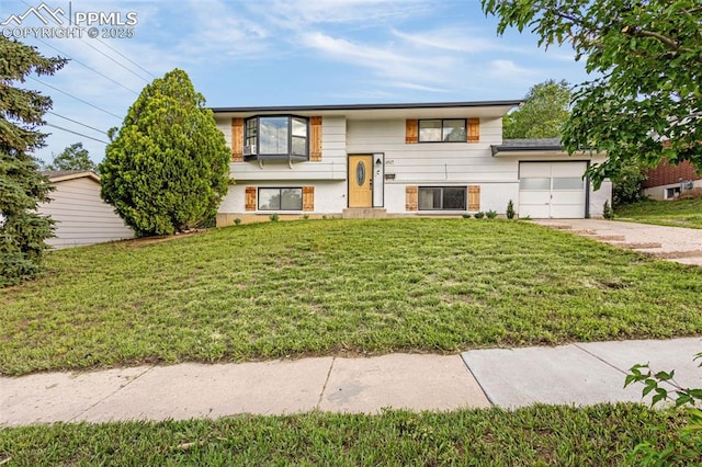 3619 Regis St, Colorado Springs, CO 80909 - bi-level home featuring an attached garage, driveway, and a front yard