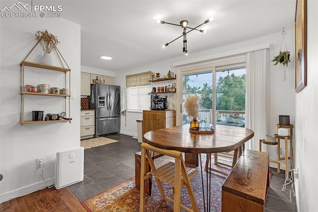 3619 Regis St, Colorado Springs, CO 80909 - dining space with baseboards and a chandelier