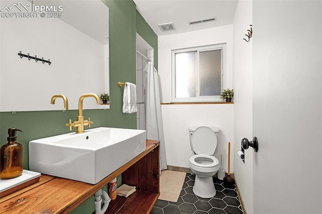 3619 Regis St, Colorado Springs, CO 80909 - full bathroom with vanity, tile patterned flooring, and curtained shower