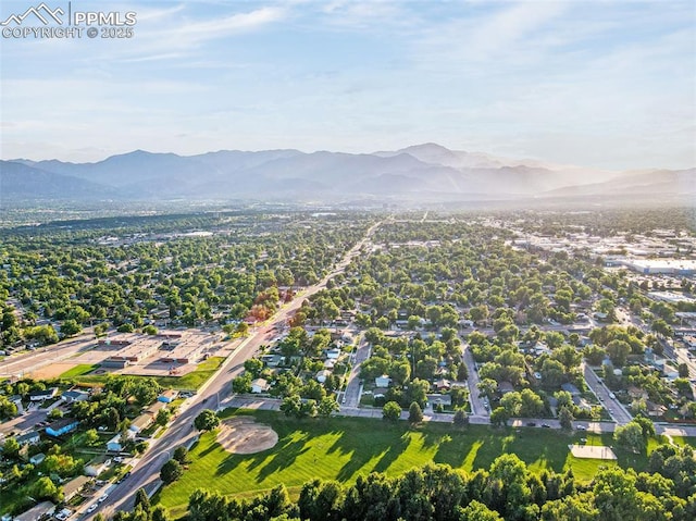 3619 Regis St, Colorado Springs, CO 80909 - aerial overview of property's location with a mountain backdrop