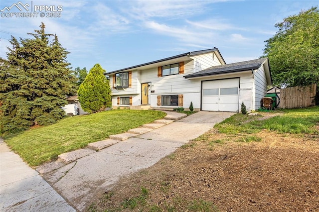 3619 Regis St, Colorado Springs, CO 80909 - split foyer home with a garage and concrete driveway