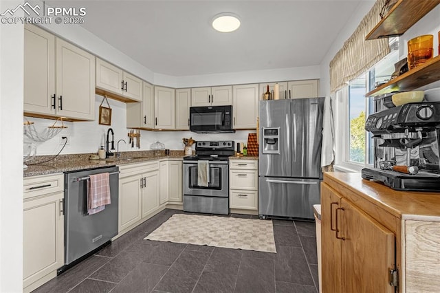 3619 Regis St, Colorado Springs, CO 80909 - kitchen with appliances with stainless steel finishes and light stone counters