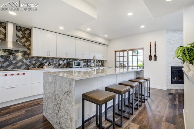 5775 Sonnet Hts, Colorado Springs, CO 80918 - kitchen featuring wall chimney exhaust hood, dark wood-type flooring, decorative backsplash, recessed lighting, and modern cabinets
