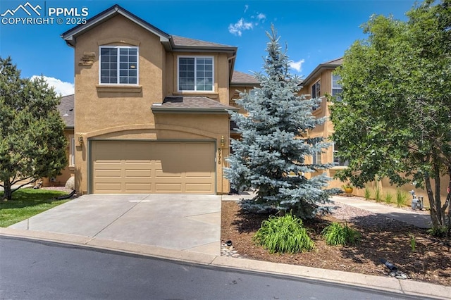 5775 Sonnet Hts, Colorado Springs, CO 80918 - view of front of property featuring a garage, stucco siding, and driveway